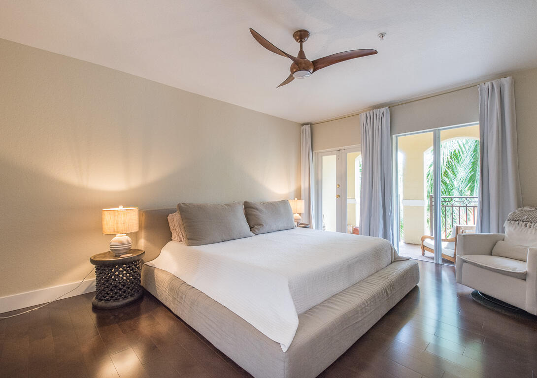 1910 Coastal Bay Boulevard Boynton Beach, FL 33435 - Photo 25 of 64 a bedroom with a large bed and a chandelier