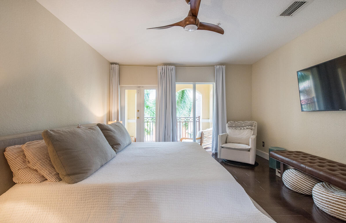 1910 Coastal Bay Boulevard Boynton Beach, FL 33435 - Photo 26 of 64 a bedroom with a bed couch and window