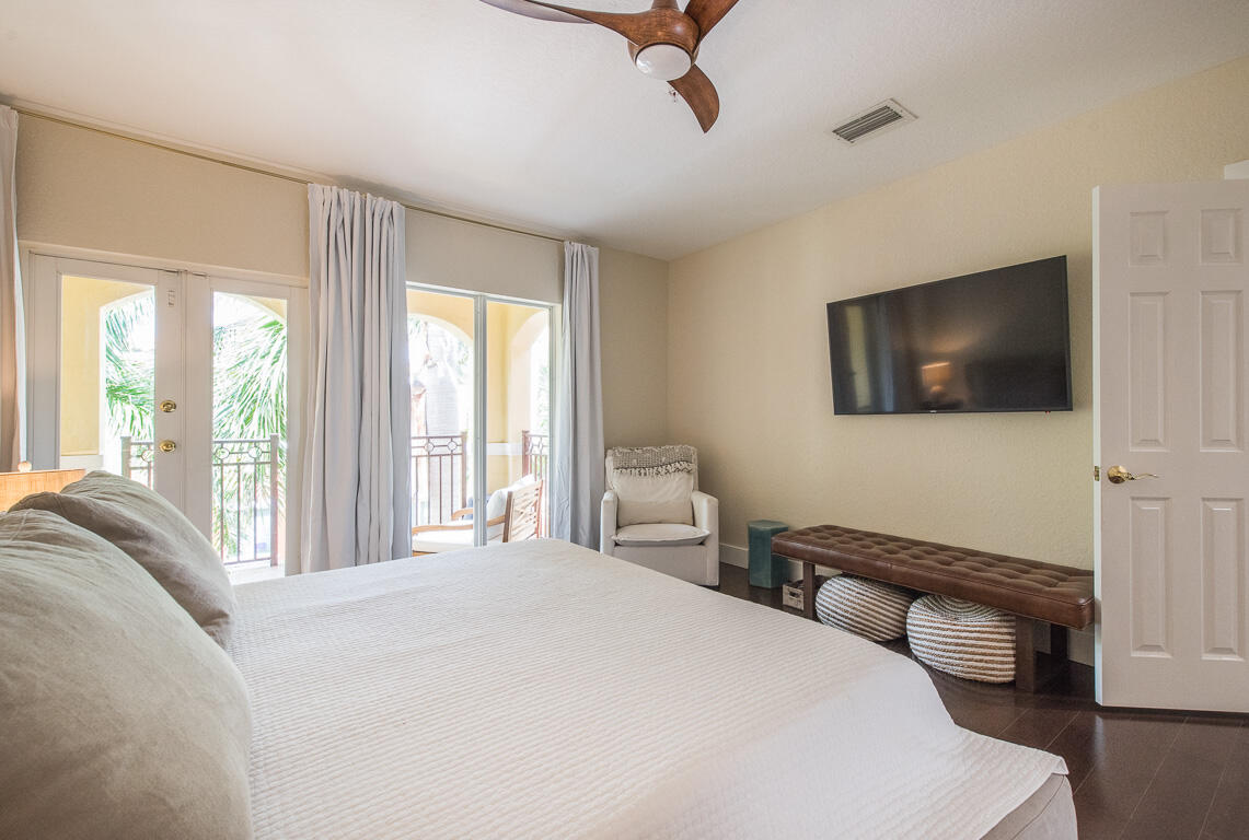 1910 Coastal Bay Boulevard Boynton Beach, FL 33435 - Photo 27 of 64 a bedroom with a bed and a flat screen tv