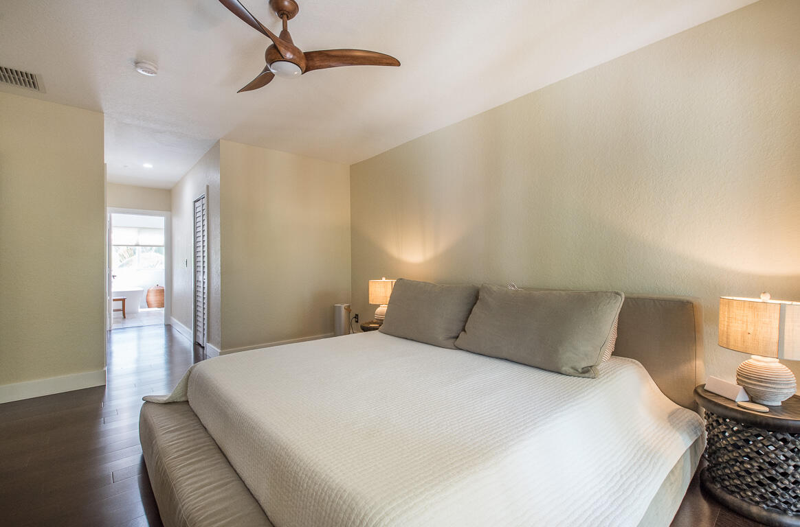 1910 Coastal Bay Boulevard Boynton Beach, FL 33435 - Photo 28 of 64 a bedroom with a bed and wooden floor