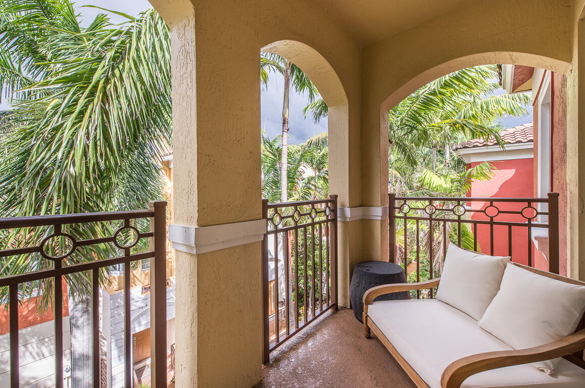 1910 Coastal Bay Boulevard Boynton Beach, FL 33435 - Photo 29 of 64 a balcony with couple of chairs and wooden floor