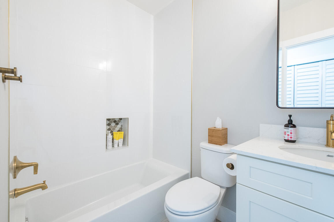 1910 Coastal Bay Boulevard Boynton Beach, FL 33435 - Photo 37 of 64 a bathroom with a sink a toilet and shower