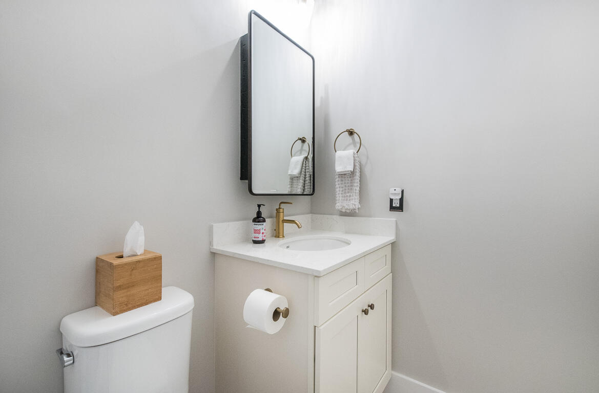 1910 Coastal Bay Boulevard Boynton Beach, FL 33435 - Photo 38 of 64 a bathroom with a toilet sink and mirror
