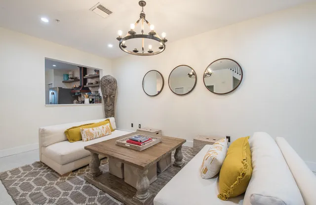 a living room with a couch and a chandelier