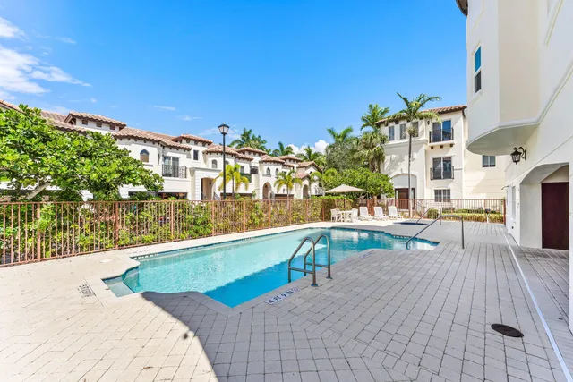 a front view of a multi story residential apartment building with a yard