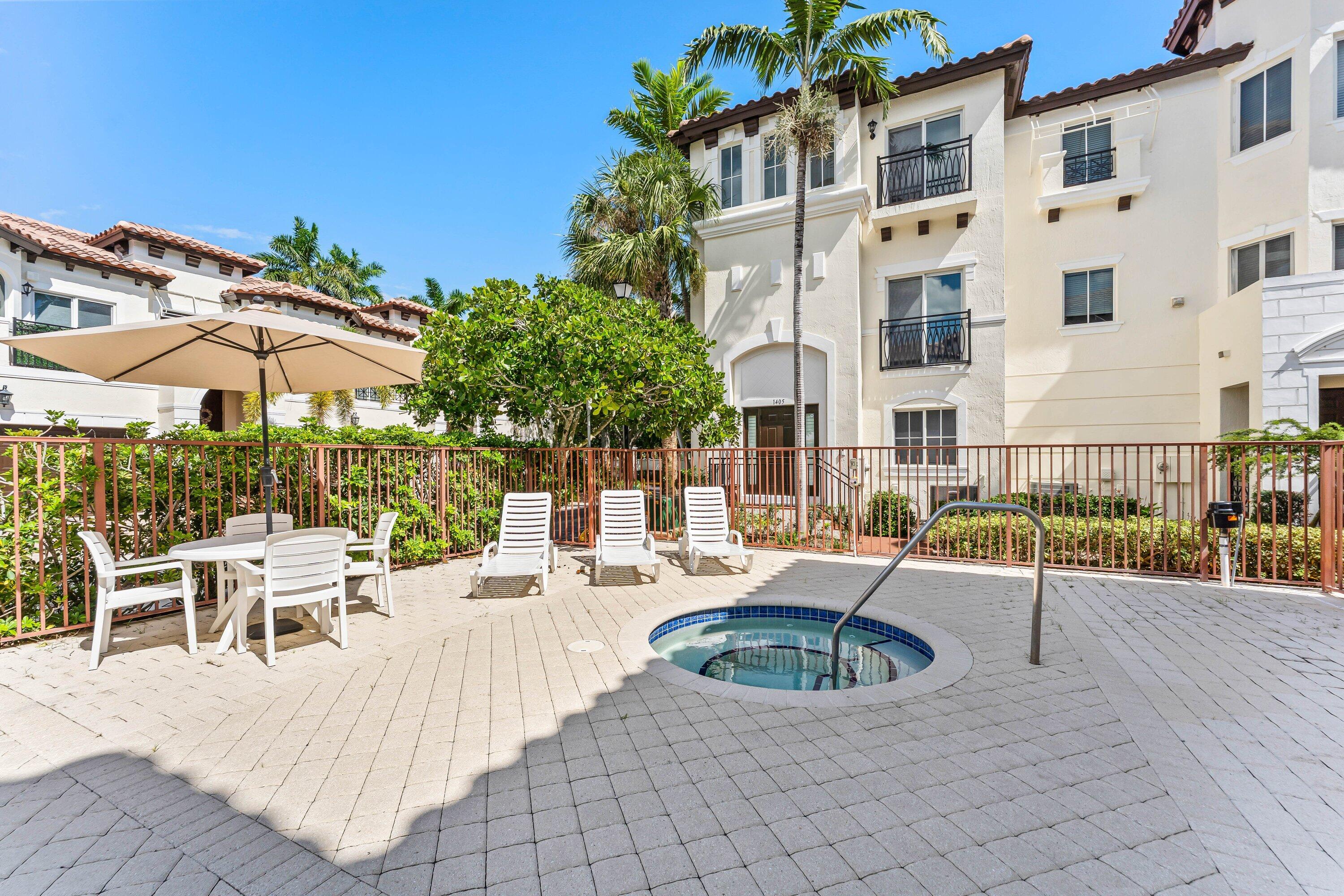 1910 Coastal Bay Boulevard Boynton Beach, FL 33435 - Photo 44 of 64 a view of a patio with a table and chairs under an umbrella