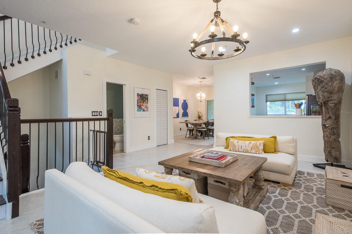 1910 Coastal Bay Boulevard Boynton Beach, FL 33435 - Photo 5 of 64 a living room with a couch and a chandelier