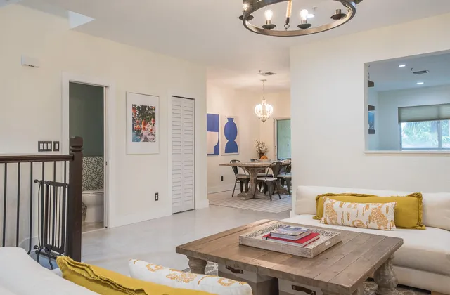 a living room with furniture and a chandelier