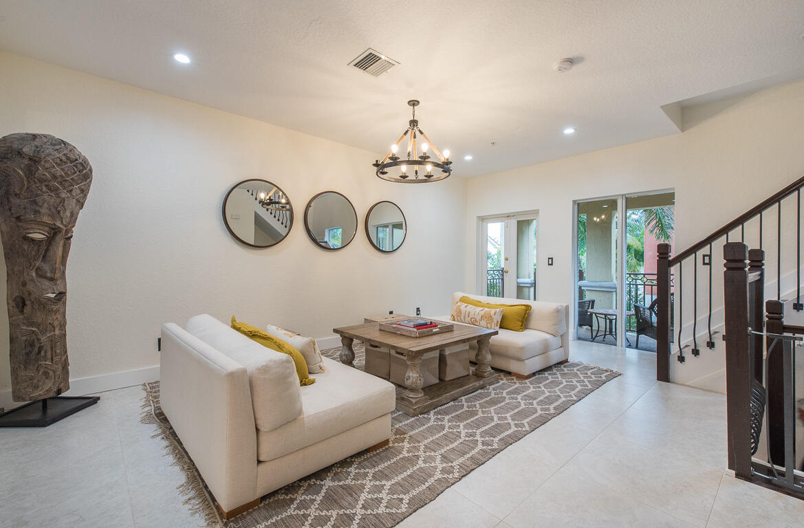 1910 Coastal Bay Boulevard Boynton Beach, FL 33435 - Photo 7 of 64 a living room with furniture and a chandelier