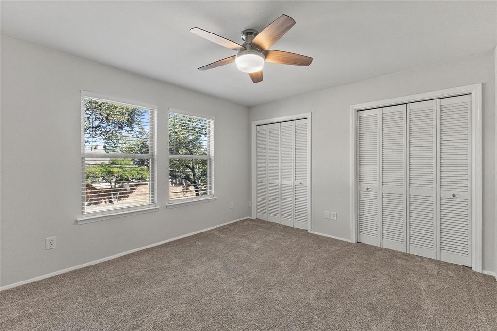 5616 Preston Oaks Road, Unit 208 Dallas, TX 75254 - Photo 6 of 16 a view of an empty room with window and a ceiling fan