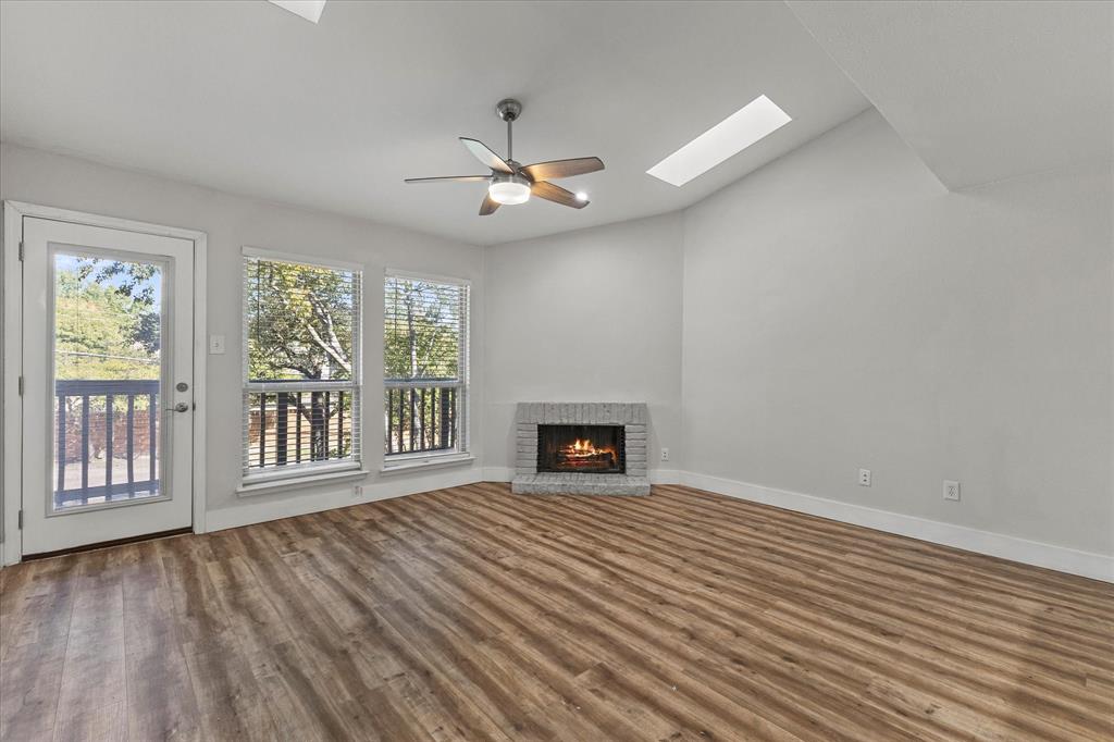 5616 Preston Oaks Road, Unit 208 Dallas, TX 75254 - Photo 8 of 16 a view of an empty room with a window and wooden floor