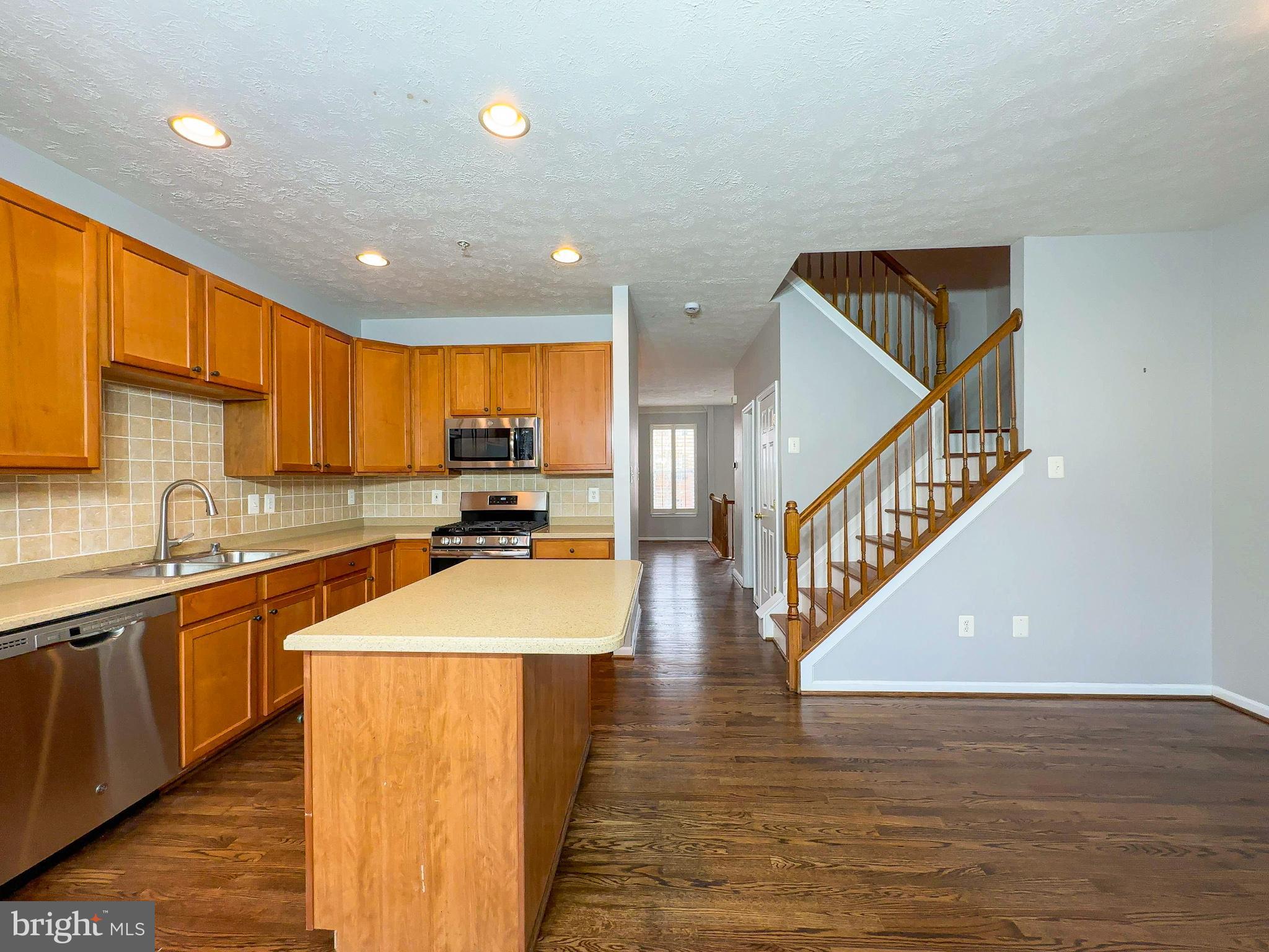 826 Lowe Road Baltimore, MD 21220 - Photo 14 of 35 a kitchen with stainless steel appliances granite countertop a sink a stove and a refrigerator