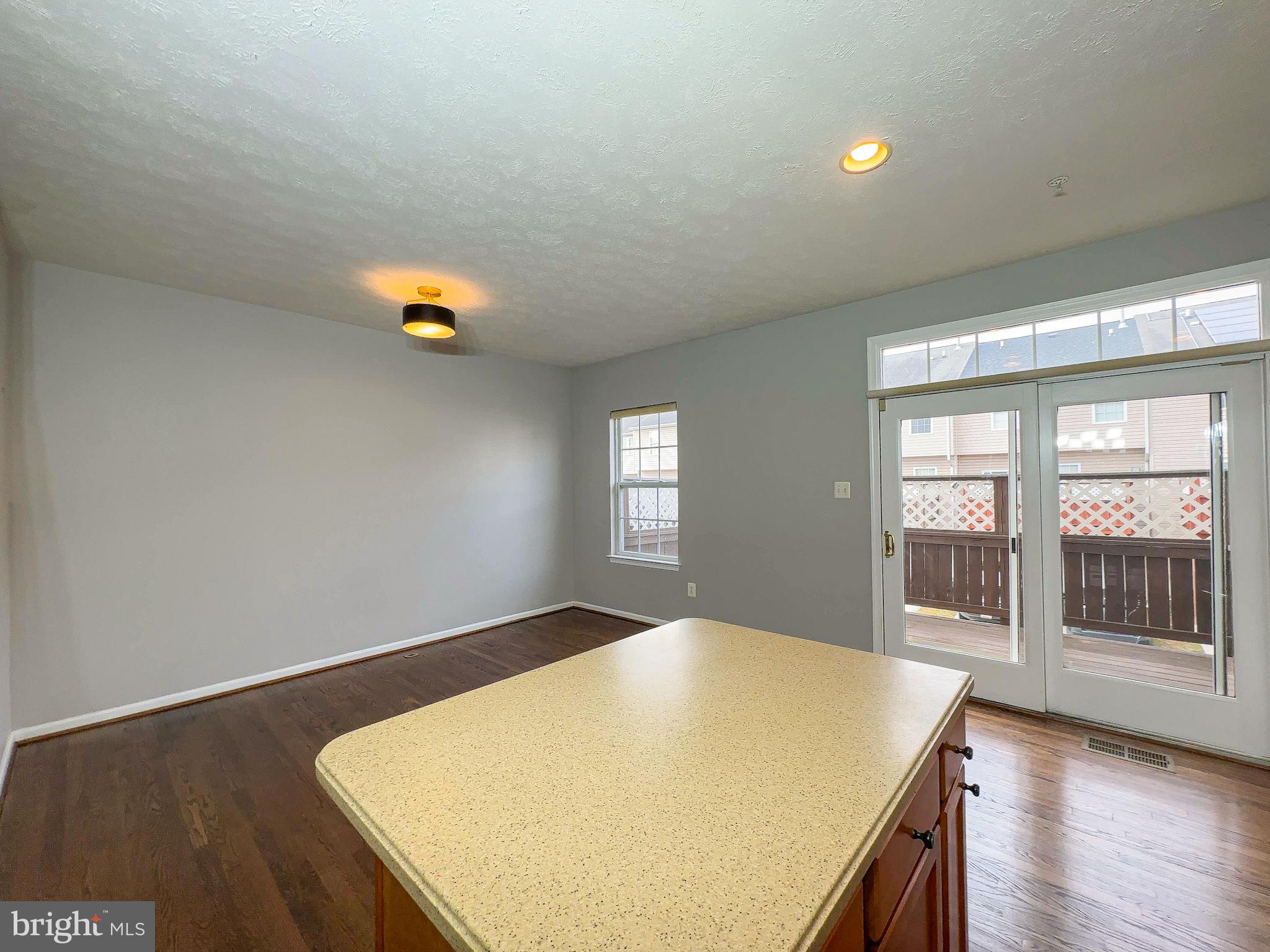 826 Lowe Road Baltimore, MD 21220 - Photo 20 of 35 a view of livingroom with kitchen and wooden floor