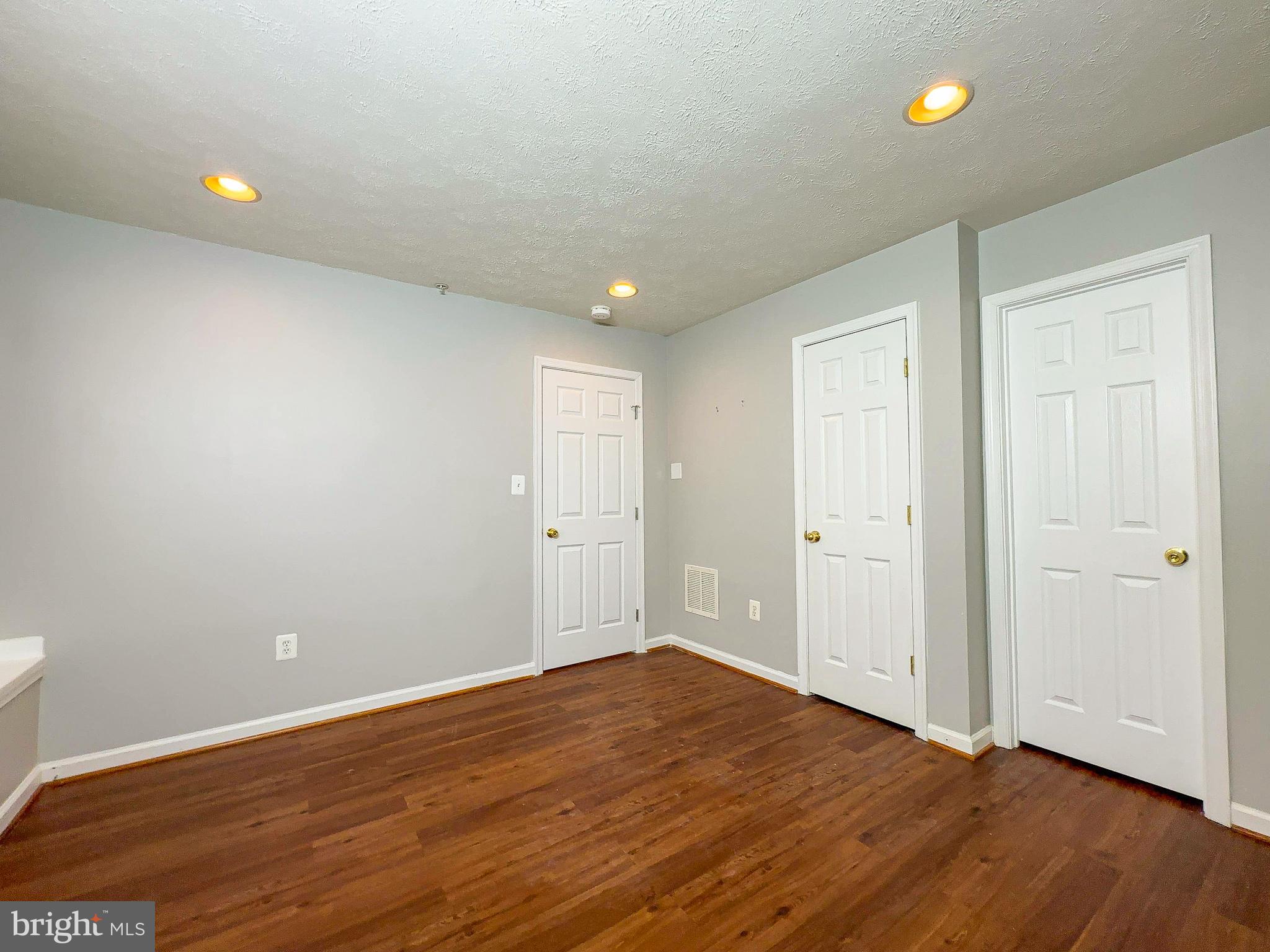 826 Lowe Road Baltimore, MD 21220 - Photo 30 of 35 a view of an empty room with wooden floor and fan