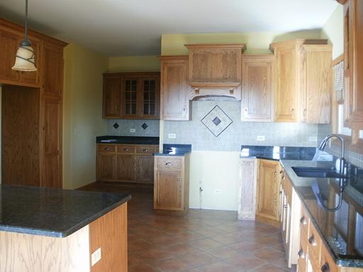1784 North 46th Road Leland, IL 60531 - Photo 3 of 16 a kitchen with stainless steel appliances granite countertop a sink and a stove next to a window