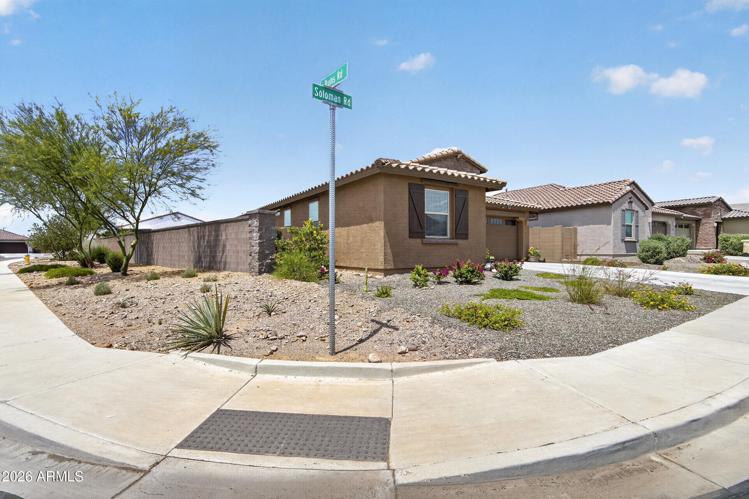 12330 East Soloman Road Gold Canyon, AZ 85118 - Photo 9 of 69 a front view of a house with a yard and potted plants