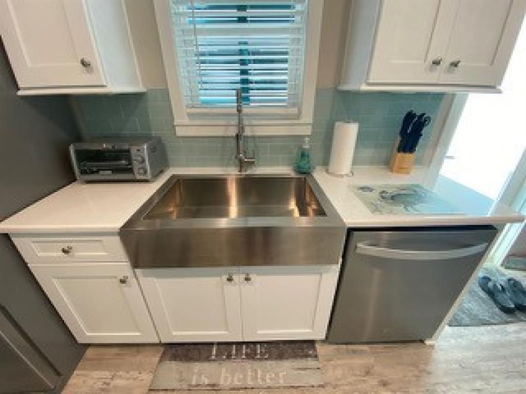 101 11th Street Marathon, FL 33051 - Photo 12 of 27 a kitchen with white cabinets and sink