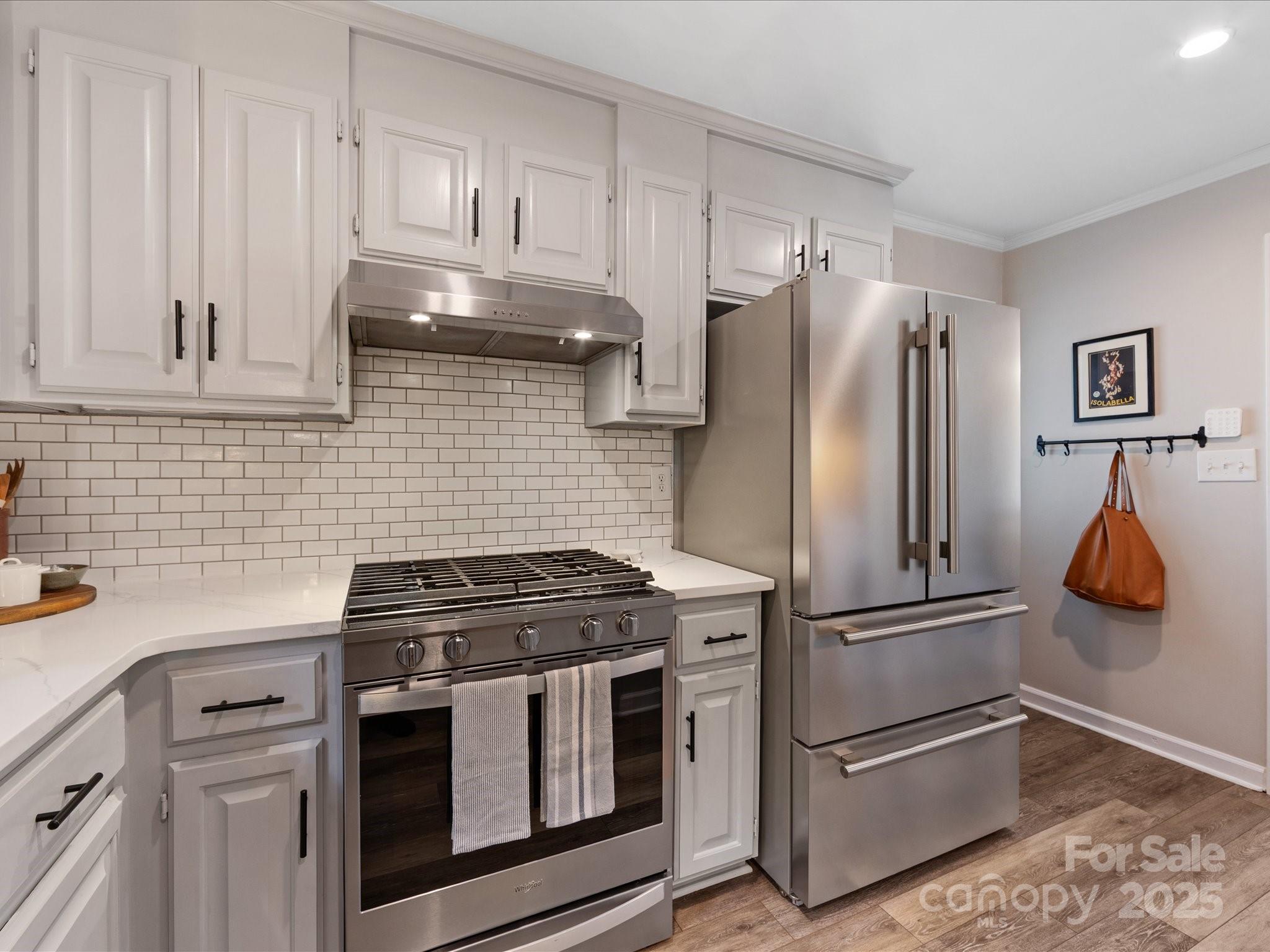 19607 Tryon Street Cornelius, NC 28031 - Photo 20 of 40 a kitchen with stainless steel appliances granite countertop a refrigerator and a stove top oven