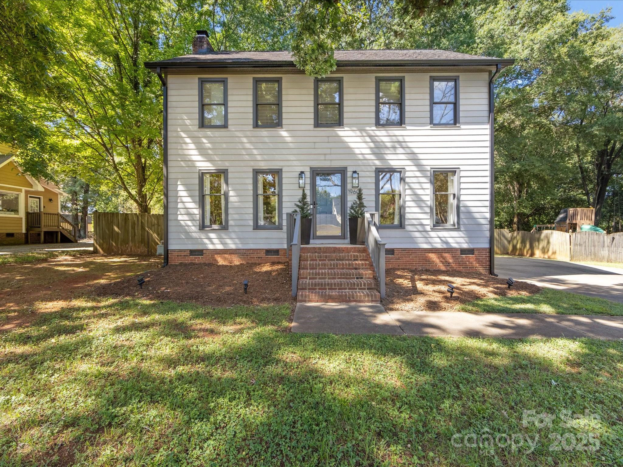 19607 Tryon Street Cornelius, NC 28031 - Photo 2 of 40 a front view of a house with a yard