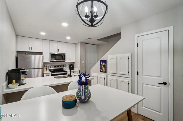 a kitchen with a refrigerator a stove a microwave and cabinets