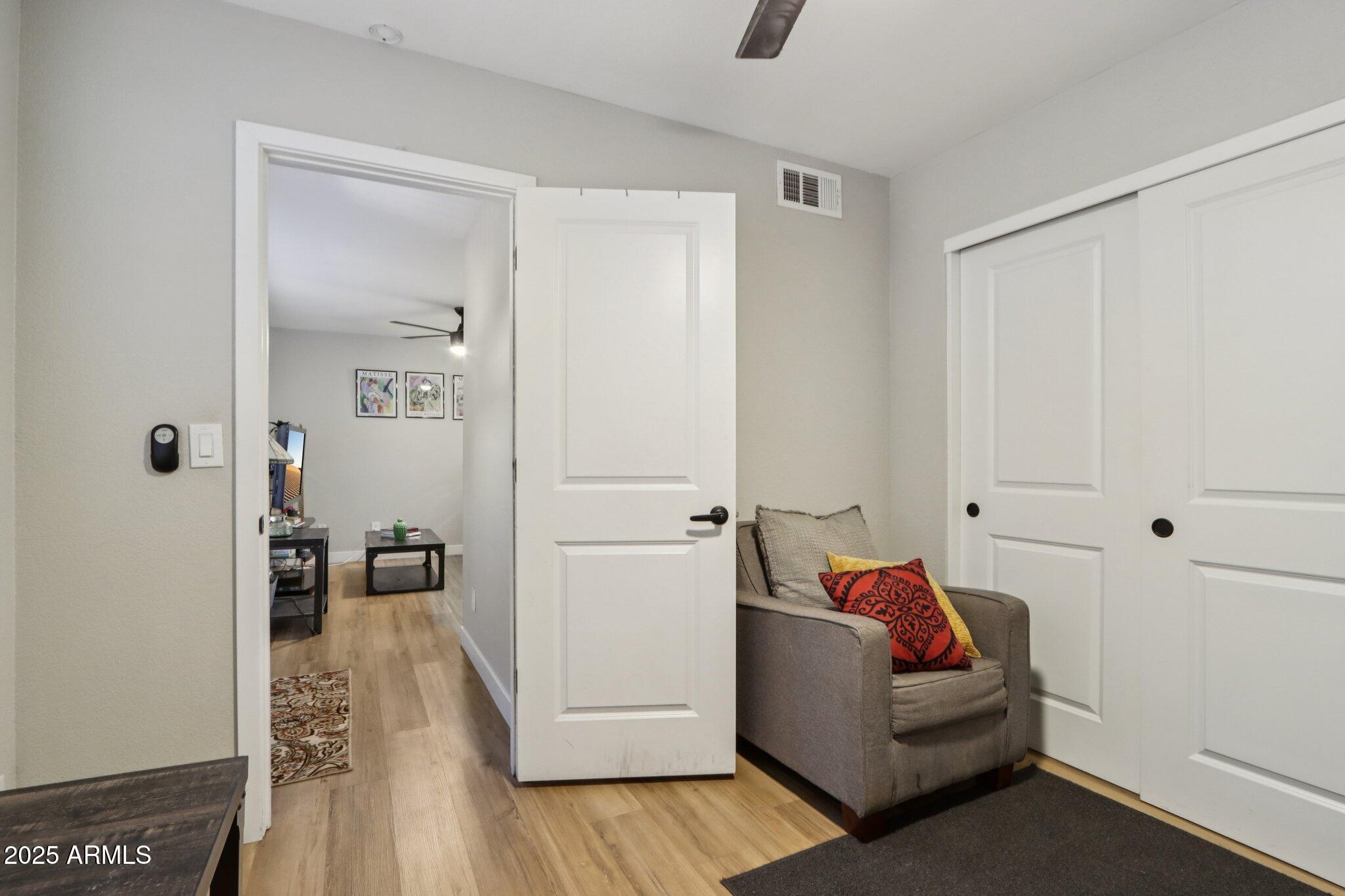510 North Alma School Road, Unit 174 Mesa, AZ 85201 - Photo 17 of 38 a living room with furniture and a wooden floor