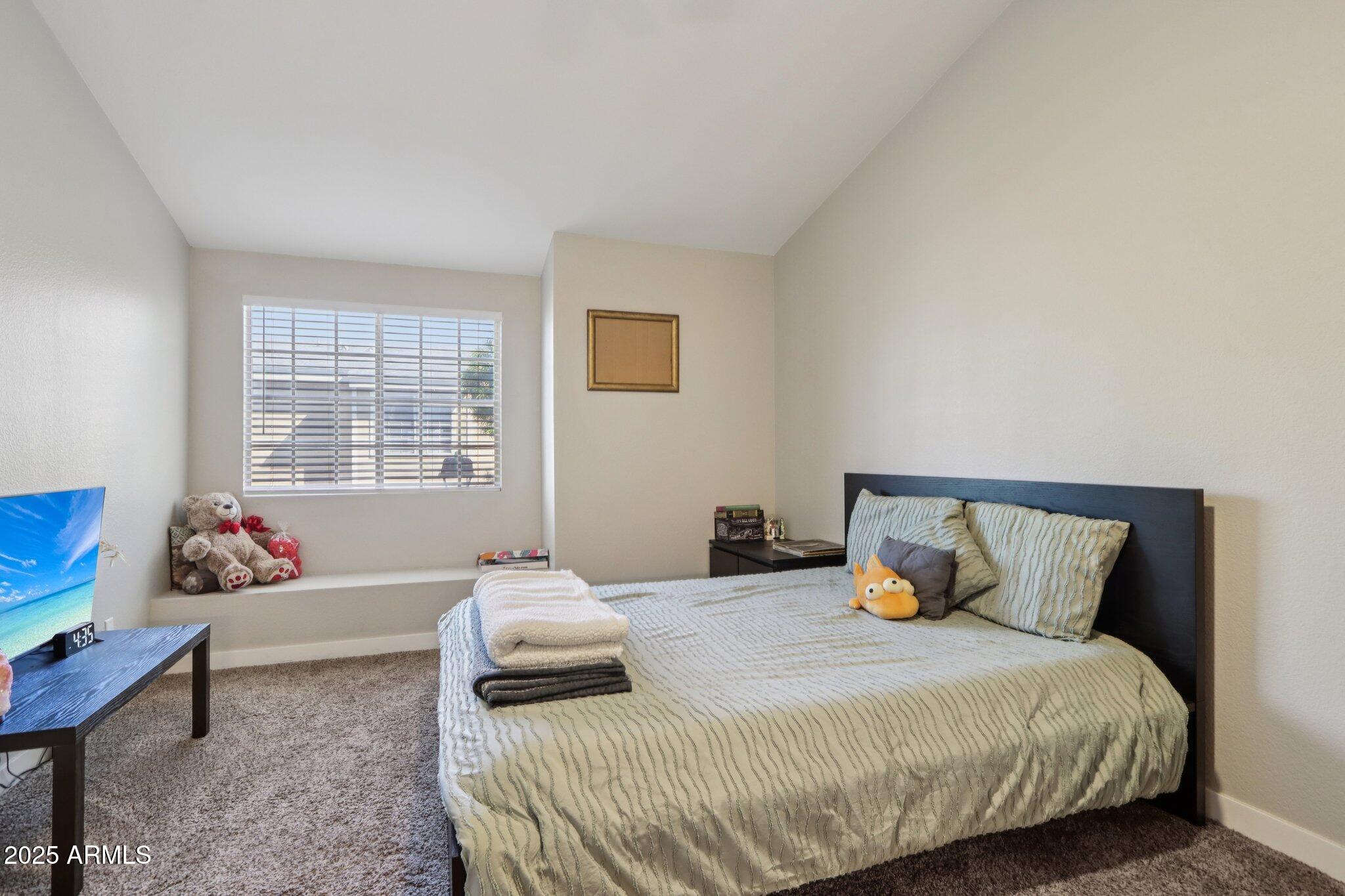 510 North Alma School Road, Unit 174 Mesa, AZ 85201 - Photo 24 of 38 a bedroom with a bed and window