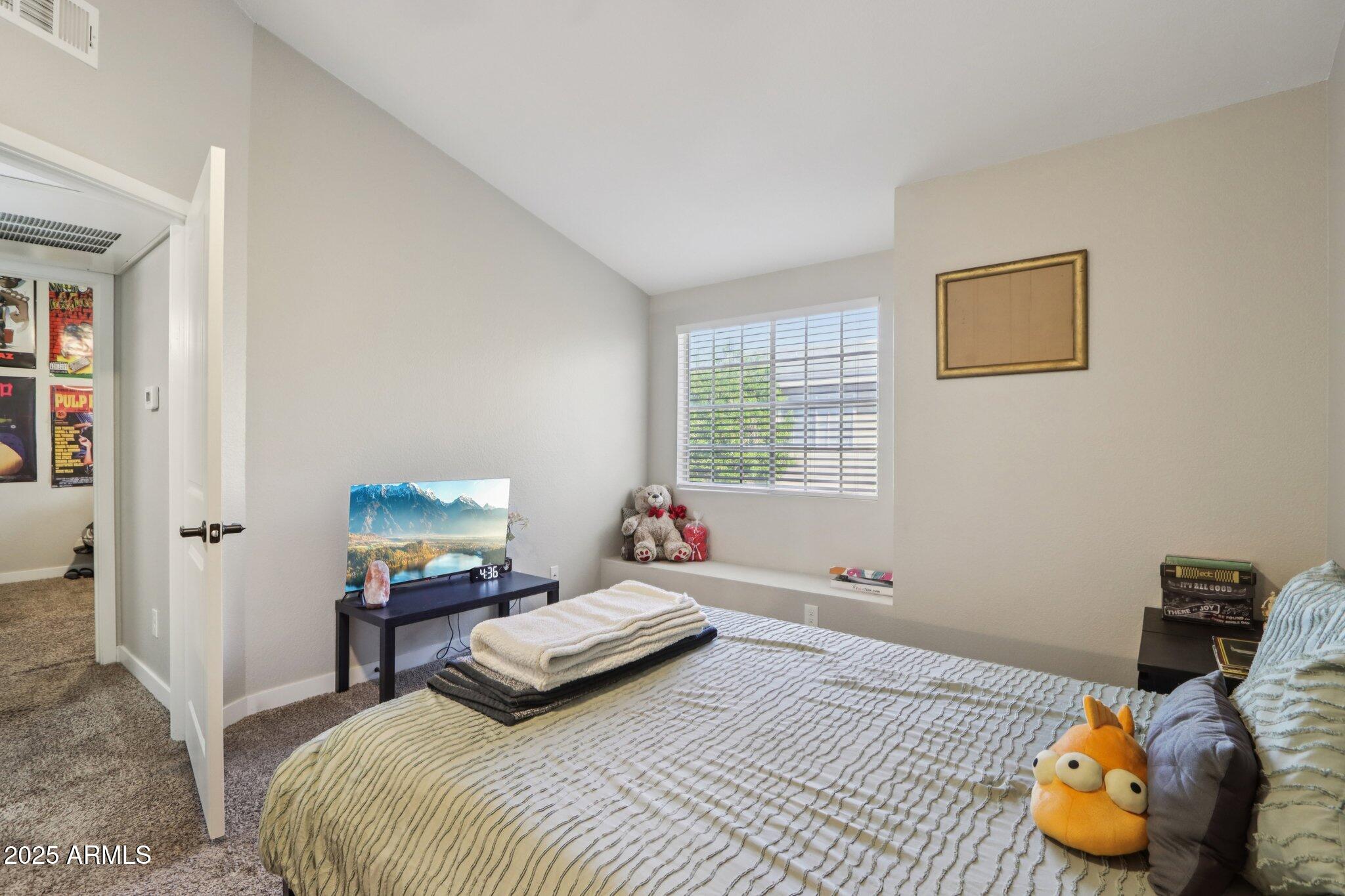 510 North Alma School Road, Unit 174 Mesa, AZ 85201 - Photo 25 of 38 a bedroom with a bed and wooden floor