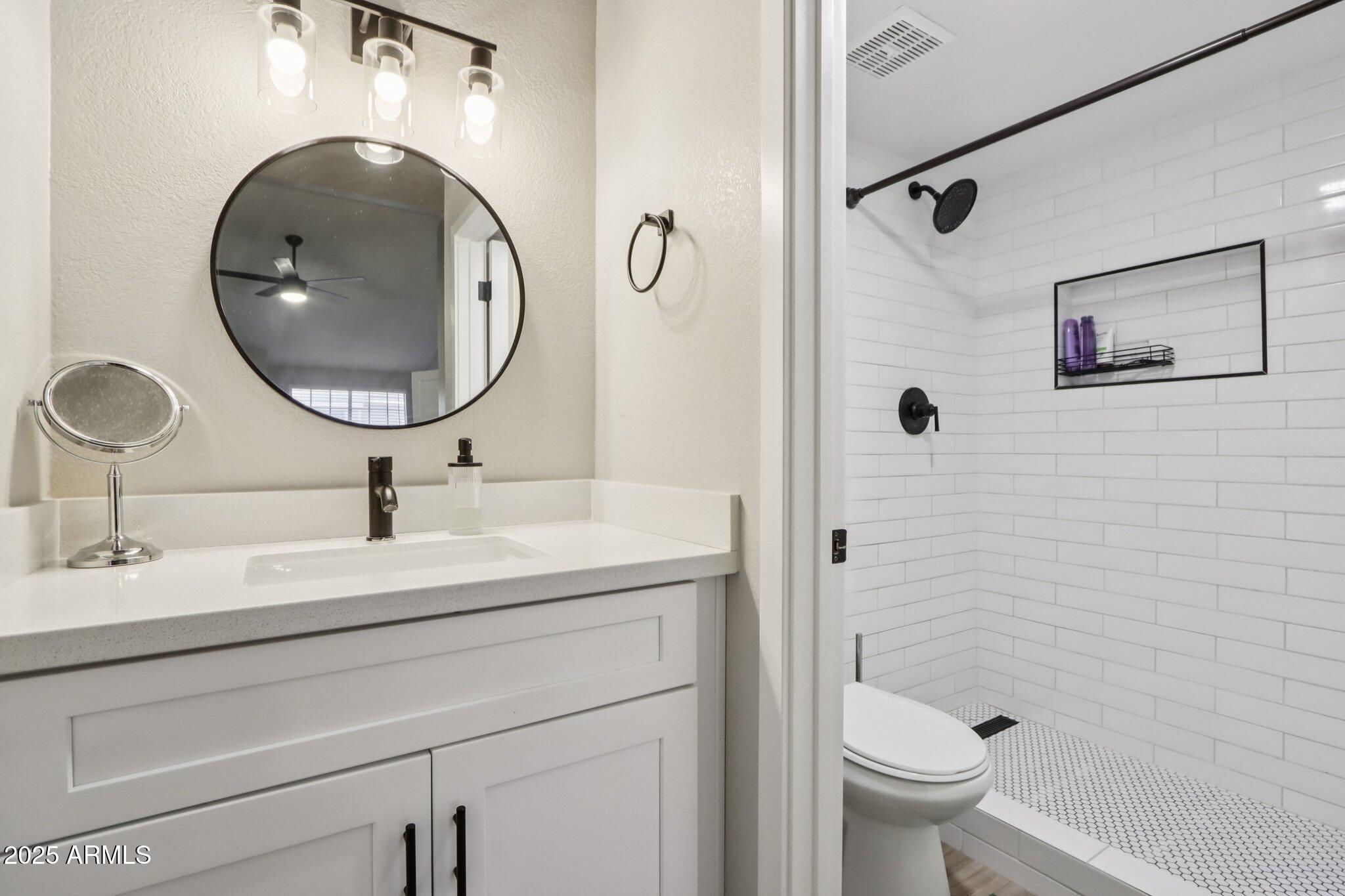 510 North Alma School Road, Unit 174 Mesa, AZ 85201 - Photo 28 of 38 a bathroom with a toilet a sink and mirror