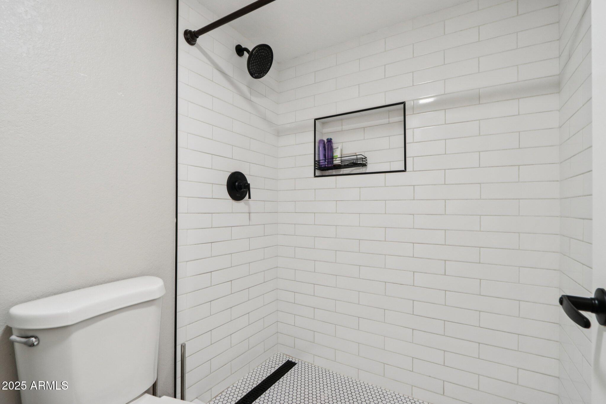 510 North Alma School Road, Unit 174 Mesa, AZ 85201 - Photo 29 of 38 a bathroom with a toilet and a shower