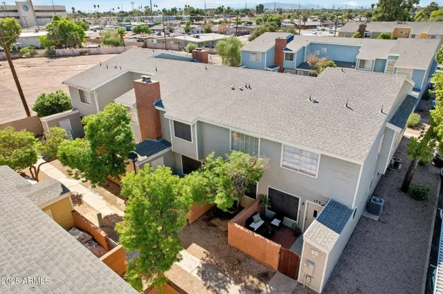 an aerial view of a house with a yard basket ball court and outdoor seating