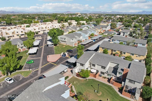 an aerial view of a house with a yard