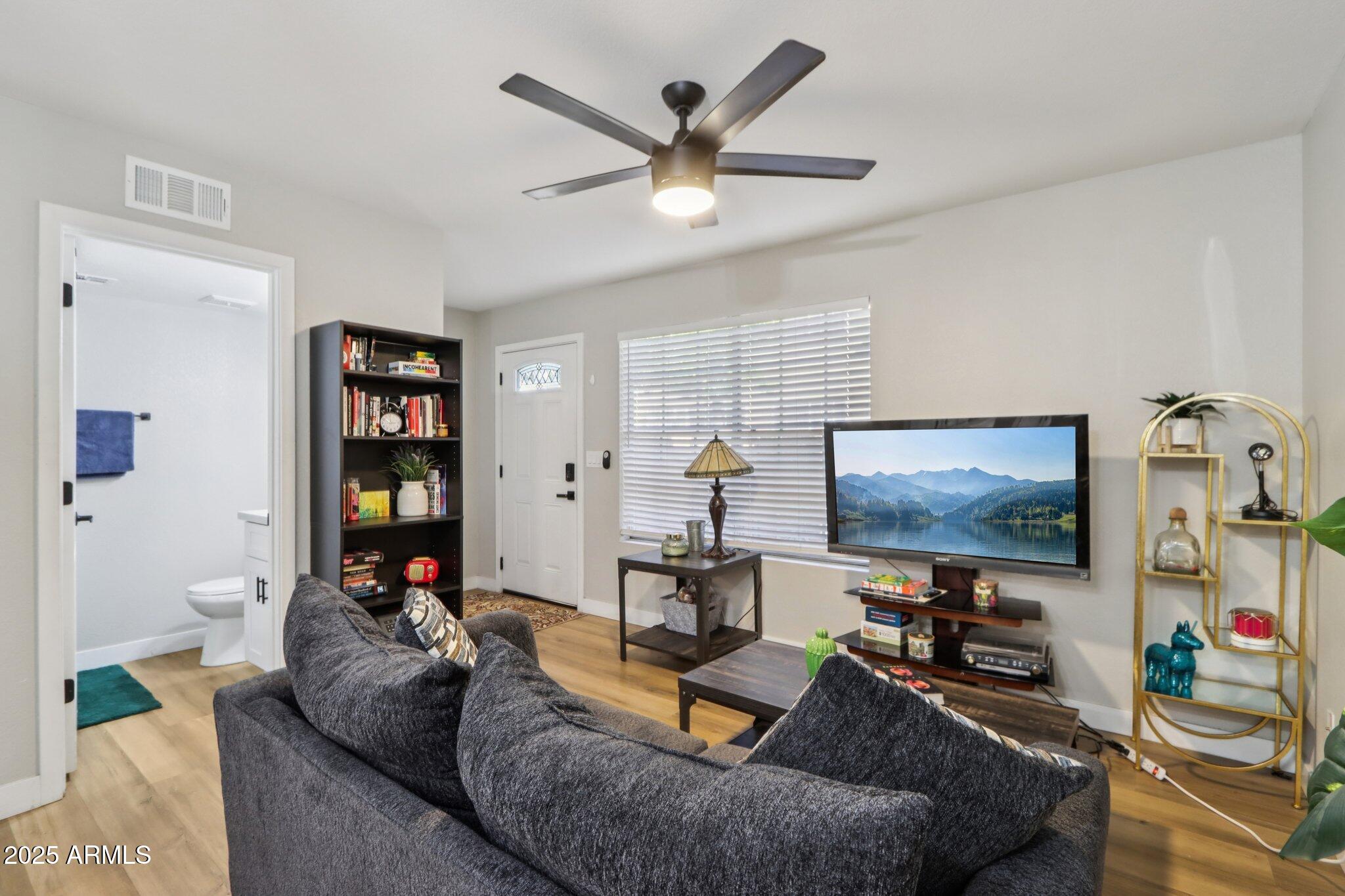 510 North Alma School Road, Unit 174 Mesa, AZ 85201 - Photo 4 of 38 a living room with furniture and a flat screen tv
