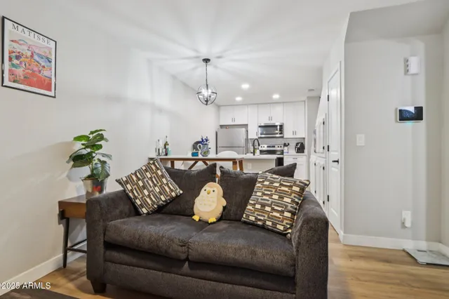 a living room with furniture and kitchen view