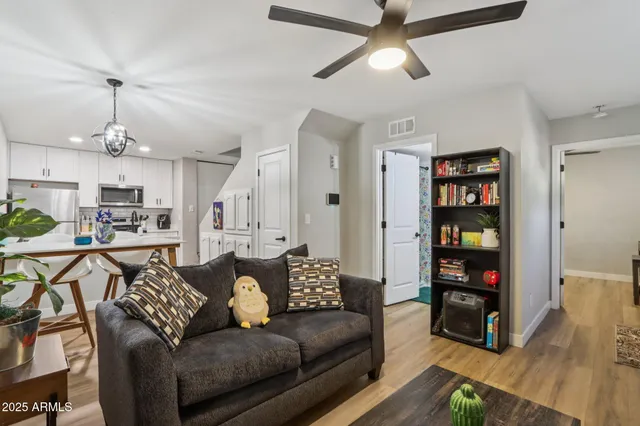 a living room with furniture and a wooden floor