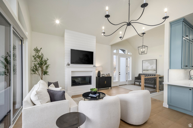 250 South Main Street, Unit 25 Alpine, UT 84004 - Photo 13 of 31 Living room with light wood-style floors, a large fireplace, a chandelier, and vaulted ceiling