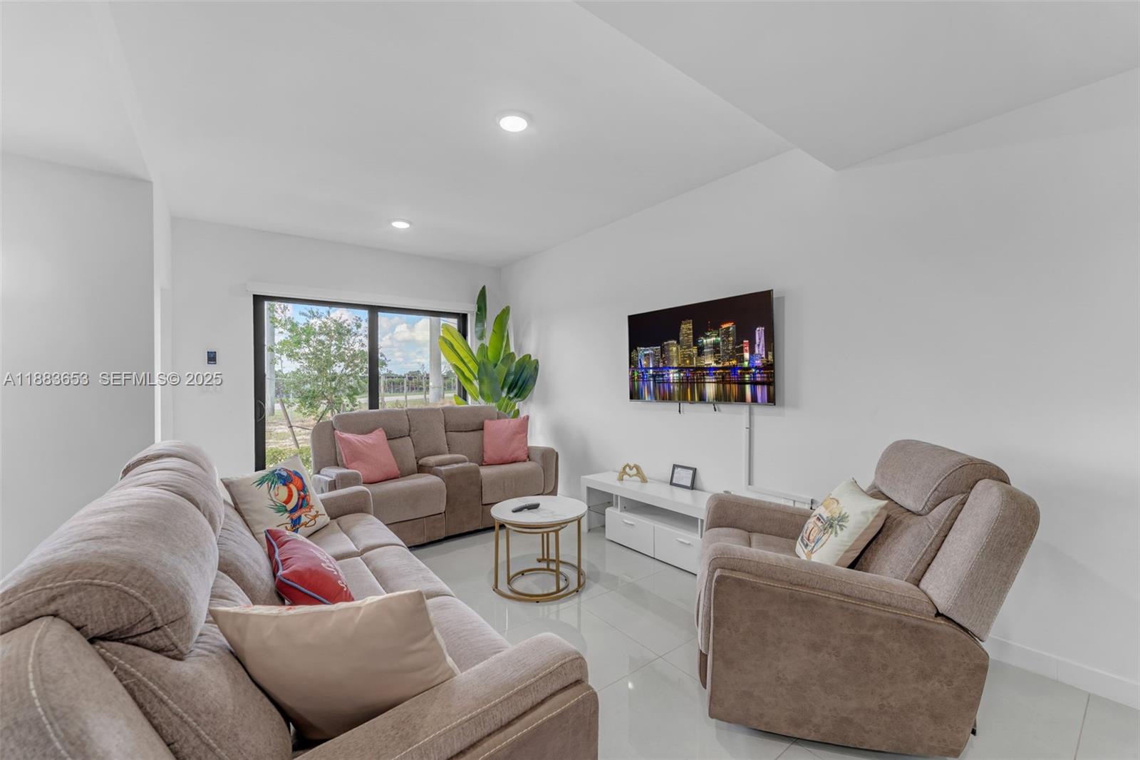 26144 Southwest 146th Court Homestead, FL 33032 - Photo 6 of 35 Bright living room with large windows and neutral tones.