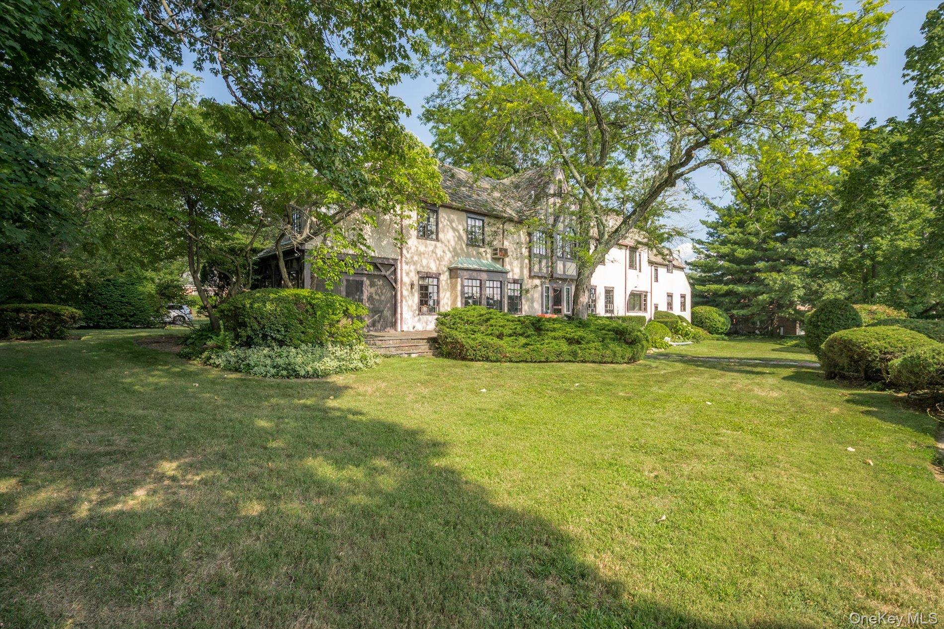 6 Shore Drive Great Neck, NY 11021 - Photo 10 of 10 View of green lawn featuring view of scattered trees