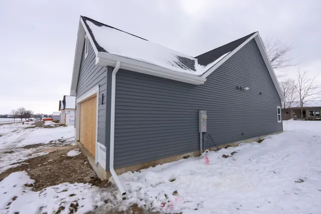 a view of a house with wooden fence