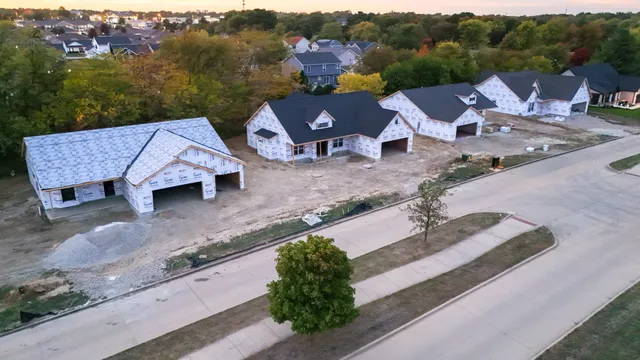 an aerial view of a house with garden space and street view