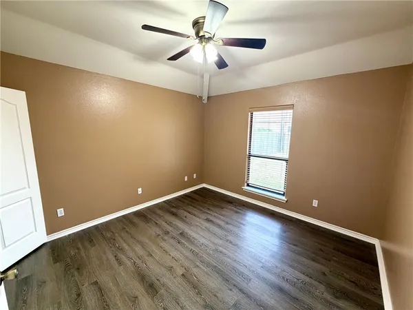 a view of room with window and ceiling fan