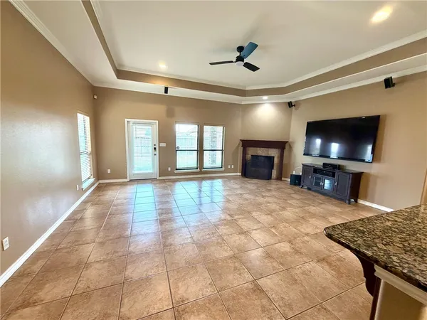 a view of a livingroom with a flat screen tv wooden floor and a window