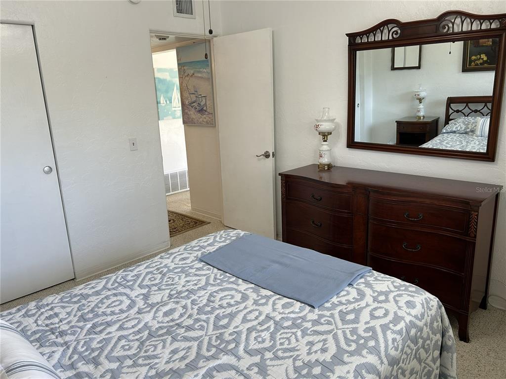 4154 57th Street North, Unit 274 Kenneth City, FL 33709 - Photo 11 of 28 a bedroom with a bed and a dresser