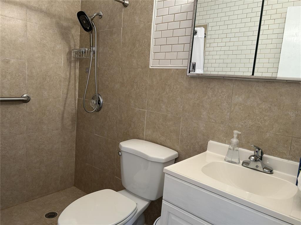 4154 57th Street North, Unit 274 Kenneth City, FL 33709 - Photo 12 of 28 a bathroom with a sink a toilet and a mirror