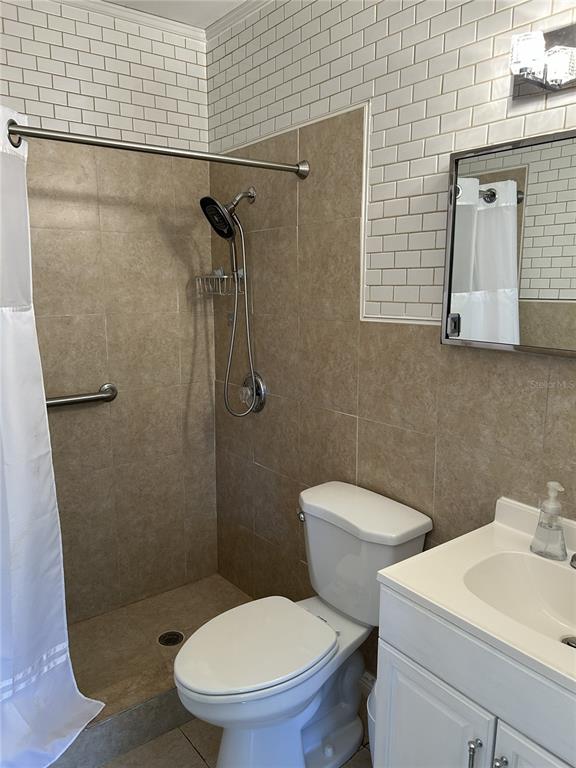 4154 57th Street North, Unit 274 Kenneth City, FL 33709 - Photo 13 of 28 a white toilet sitting next to a bathroom sink