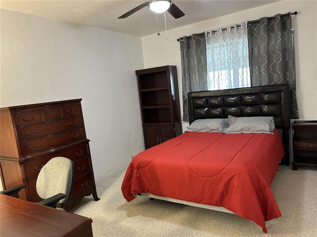4154 57th Street North, Unit 274 Kenneth City, FL 33709 - Photo 14 of 28 a bedroom with a bed and window