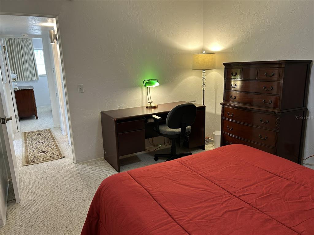 4154 57th Street North, Unit 274 Kenneth City, FL 33709 - Photo 16 of 28 a bedroom with a bed and a television