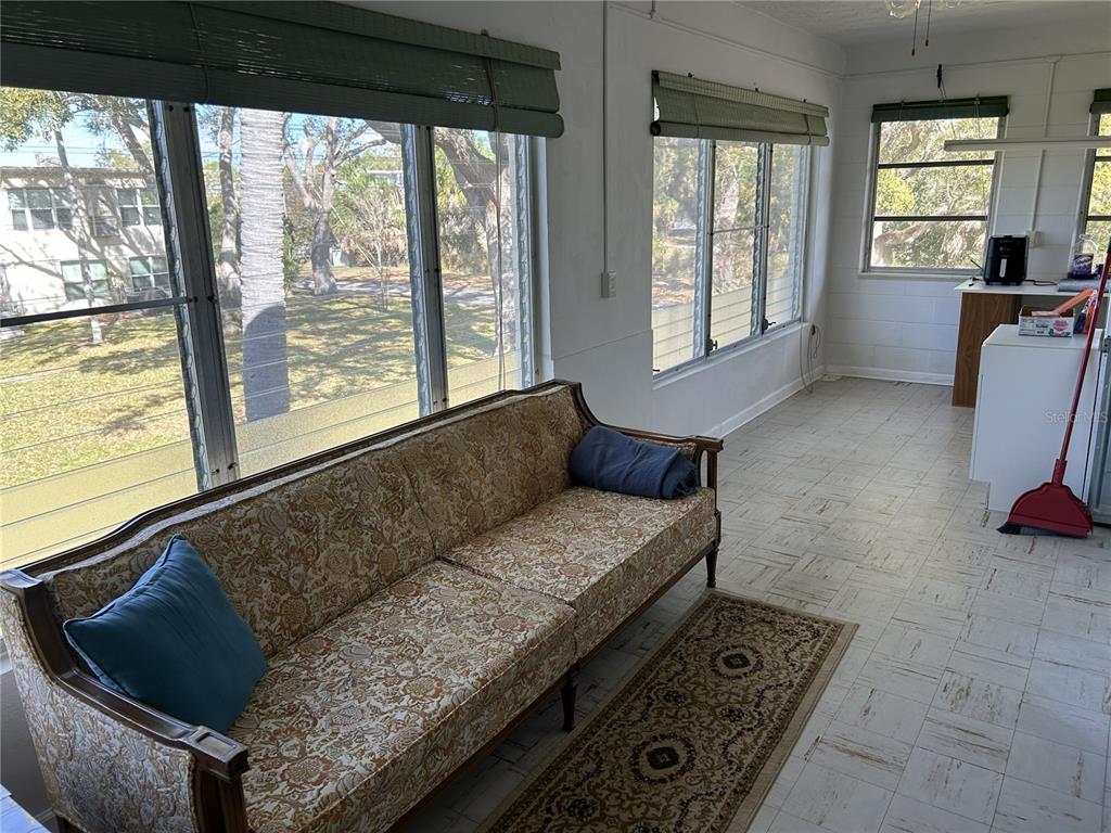 4154 57th Street North, Unit 274 Kenneth City, FL 33709 - Photo 20 of 28 a living room with furniture and a floor to ceiling window