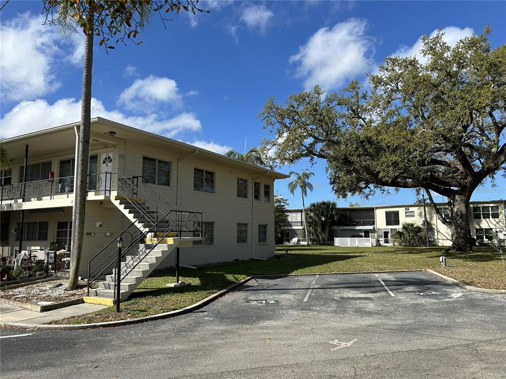 4154 57th Street North, Unit 274 Kenneth City, FL 33709 - Photo 22 of 28 a front view of a house with a yard