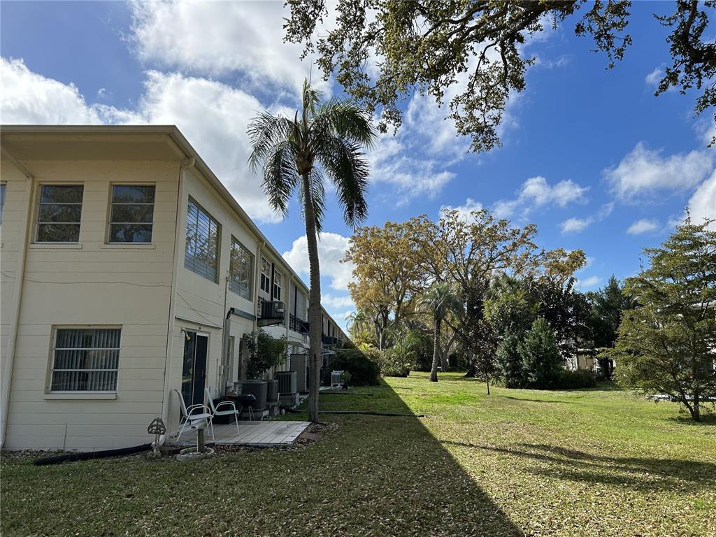 4154 57th Street North, Unit 274 Kenneth City, FL 33709 - Photo 25 of 28 a view of a house with a yard