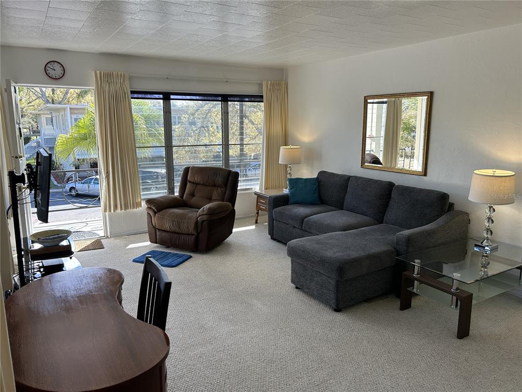 4154 57th Street North, Unit 274 Kenneth City, FL 33709 - Photo 5 of 28 a living room with furniture and a large window